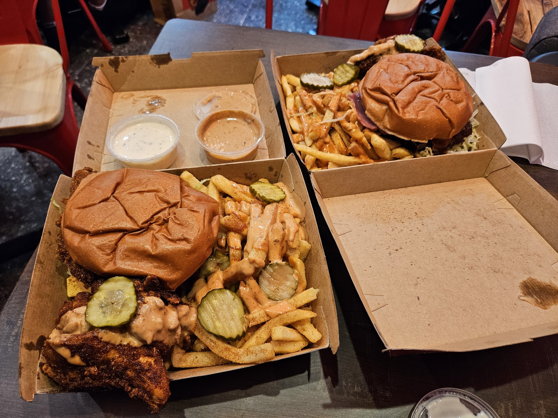 Fried Brothers box meal with burger, chicken, fries, and sauces